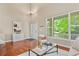 Open-concept living room featuring hardwood floors, bright windows and contemporary decor at 5755 W Berry Ave, Denver, CO 80123