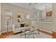 Cozy living room with hardwood floors, bright windows, and neutral-toned contemporary decor at 5755 W Berry Ave, Denver, CO 80123