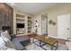 Comfortable living room featuring a corner fireplace, built-in shelving, and a plush sectional sofa at 5755 W Berry Ave, Denver, CO 80123