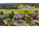 Expansive estate on a golf course, with a circular driveway and lush landscaping, near a frozen lake at 73 Glenmoor Dr, Cherry Hills Village, CO 80113