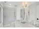 Bathroom featuring dual sinks, a large framed mirror and a glass-enclosed shower at 73 Glenmoor Dr, Cherry Hills Village, CO 80113