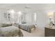 Bright bedroom with two beds, patterned bedding and view to bathroom at 73 Glenmoor Dr, Cherry Hills Village, CO 80113
