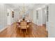Dining room with decorative wallpaper, hardwood floors, and a chandelier at 73 Glenmoor Dr, Cherry Hills Village, CO 80113