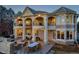 Stunning exterior view of a luxury home with arched balconies and a spacious outdoor patio at 73 Glenmoor Dr, Cherry Hills Village, CO 80113