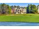 Expansive home with lush green lawn and pond, showcasing its impressive architecture and landscaping at 73 Glenmoor Dr, Cherry Hills Village, CO 80113