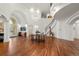 Elegant foyer with a chandelier, curved staircase, and hardwood floors create a grand entrance at 73 Glenmoor Dr, Cherry Hills Village, CO 80113