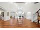 Light-filled foyer featuring hardwood floors, a striking chandelier, and open access to living spaces at 73 Glenmoor Dr, Cherry Hills Village, CO 80113