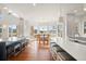 Bright kitchen featuring hardwood floors, island with seating, and an adjacent dining area with scenic views at 73 Glenmoor Dr, Cherry Hills Village, CO 80113