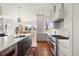 Kitchen featuring stainless steel appliances, stone countertops, and an adjacent dining area with scenic views at 73 Glenmoor Dr, Cherry Hills Village, CO 80113