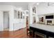 Open concept kitchen with hardwood floors featuring a wet bar and an island with seating at 73 Glenmoor Dr, Cherry Hills Village, CO 80113