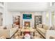Bright living room featuring a fireplace, large windows and comfortable seating at 73 Glenmoor Dr, Cherry Hills Village, CO 80113