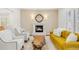 Cozy living room with a fireplace, comfortable seating, and unique coffee table at 73 Glenmoor Dr, Cherry Hills Village, CO 80113