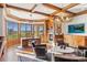 Office featuring wood beamed ceilings, fireplace, golf course views, and an antler chandelier at 73 Glenmoor Dr, Cherry Hills Village, CO 80113