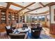 Spacious office with built-in shelves, an antler chandelier, and a bay window with golf course views at 73 Glenmoor Dr, Cherry Hills Village, CO 80113