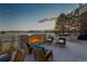 Outdoor seating area with a fireplace offering cozy ambiance and views of the golf course at 73 Glenmoor Dr, Cherry Hills Village, CO 80113