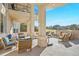 Covered patio with outdoor fireplace and comfortable seating offers a relaxing outdoor retreat at 73 Glenmoor Dr, Cherry Hills Village, CO 80113