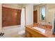 Bathroom featuring a sink with a granite countertop, bathtub, and a window with scenic views at 180 Outpost Ln, Evergreen, CO 80439
