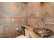 Stylish bathroom with unique tile work, a glass bowl sink, and modern fixtures at 180 Outpost Ln, Evergreen, CO 80439