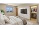 Bedroom with a large tv, walk-in closet, neutral tones, and a cozy atmosphere at 180 Outpost Ln, Evergreen, CO 80439