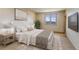 Cozy bedroom with a serene atmosphere, complemented by a window with mountain views and soft, neutral tones at 180 Outpost Ln, Evergreen, CO 80439