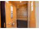 Interior view of a wooden elevator with safety gate and call buttons at 180 Outpost Ln, Evergreen, CO 80439