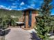 Beautiful stone home with black trim, mountain views, and a large driveway at 180 Outpost Ln, Evergreen, CO 80439