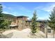 Stunning stone home boasts a modern design with expansive windows and a spacious driveway at 180 Outpost Ln, Evergreen, CO 80439