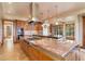 Spacious kitchen with a large island, stainless steel appliances, and wood cabinets at 180 Outpost Ln, Evergreen, CO 80439