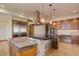 Stunning kitchen featuring stone accents, stainless steel appliances, and a granite countertop island at 180 Outpost Ln, Evergreen, CO 80439