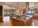 Gourmet kitchen featuring granite countertops, a large island, stainless steel appliances and scenic views at 180 Outpost Ln, Evergreen, CO 80439
