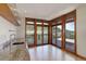 Kitchen area with stainless sink offers views of the mountain terrain beyond the balcony at 180 Outpost Ln, Evergreen, CO 80439
