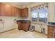 Convenient laundry room featuring sleek cabinetry and a large window with scenic mountain views at 180 Outpost Ln, Evergreen, CO 80439