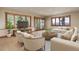 Comfortable living room with neutral furniture, scenic views, and an entertainment center at 180 Outpost Ln, Evergreen, CO 80439