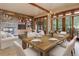 Spacious and naturally lit open floorplan integrating living, dining, and outdoor areas at 180 Outpost Ln, Evergreen, CO 80439