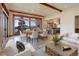 Bright living area with mountain views, dining space, and access to the kitchen at 180 Outpost Ln, Evergreen, CO 80439