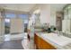 Bright main bathroom with a luxurious soaking tub, granite countertops, and a scenic view at 180 Outpost Ln, Evergreen, CO 80439
