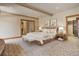 Spacious main bedroom featuring a walk-in closet, neutral tones, and access to an ensuite bathroom at 180 Outpost Ln, Evergreen, CO 80439