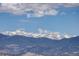 Beautiful mountain range with snow-capped peaks under a partly cloudy blue sky at 180 Outpost Ln, Evergreen, CO 80439