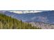 Breathtaking snow-capped mountains in the distance surrounded by evergreen trees and hills at 180 Outpost Ln, Evergreen, CO 80439