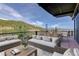 Expansive patio area with comfortable seating and breathtaking mountain views at 180 Outpost Ln, Evergreen, CO 80439