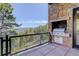Outdoor kitchen area with a built-in grill, stone accents, and picturesque mountain views at 180 Outpost Ln, Evergreen, CO 80439