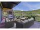 Cozy outdoor patio with a stone fireplace, comfortable seating, and scenic mountain views at 180 Outpost Ln, Evergreen, CO 80439