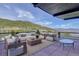 Inviting patio area with comfortable lounge seating and stunning mountain views at 180 Outpost Ln, Evergreen, CO 80439