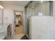 Glass shower with stylish fixtures next to a vanity with granite countertops and a walk-in closet at 180 Outpost Ln, Evergreen, CO 80439