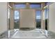 The soaking tub with a scenic view is framed by windows, letting in natural light, and has granite countertops at 180 Outpost Ln, Evergreen, CO 80439