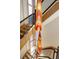 Unique, multi-colored pendant light hangs in a stairway with black metal railing at 180 Outpost Ln, Evergreen, CO 80439