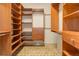 Spacious walk-in closet boasts ample shelving, drawers and custom wood finishes at 180 Outpost Ln, Evergreen, CO 80439