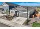 Beautiful shot of the home and its yard with new landscaping and a driveway at 476 Silver Rock Trl, Castle Rock, CO 80104
