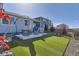 Inviting backyard with synthetic lawn, patio, and comfortable seating, perfect for outdoor relaxation and entertaining at 476 Silver Rock Trl, Castle Rock, CO 80104