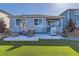 Backyard with artificial grass, covered grill, patio with seating offering a cozy outdoor living space at 476 Silver Rock Trl, Castle Rock, CO 80104